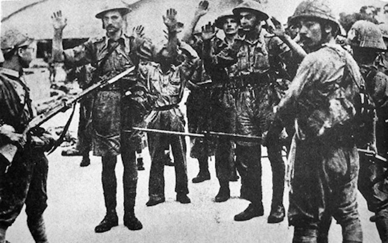 Surrendering troops held at gunpoint by Japanese infantry